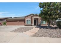 Charming single-story home with desert landscaping, a three-car garage, and a covered front entry at 10504 E Diamond Ave, Mesa, AZ 85208