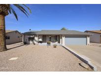 Charming single-story home with a well-manicured desert landscape and a welcoming entrance at 1056 S 81St St, Mesa, AZ 85208