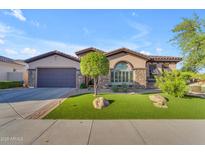 Beautiful single-story home featuring well-manicured front yard and a two-car garage at 15716 W Sheridan St, Goodyear, AZ 85395