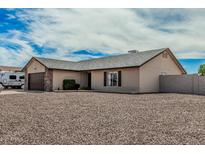 Charming single-story home featuring a stone-accented garage, neutral stucco, and low-maintenance desert landscaping at 3047 W Sandra Ter, Phoenix, AZ 85053