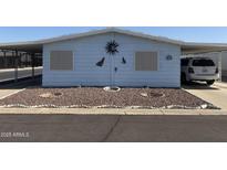 Charming home featuring desert landscaping, carport, and rustic wall decorations at 3330 E Main St # 256, Mesa, AZ 85213