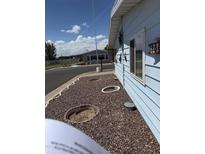 Charming single-story home with light-blue siding and decorative yard details at 3330 E Main St # 256, Mesa, AZ 85213
