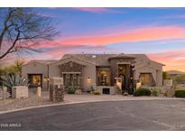 Stunning single-story home boasts stone accents, a tile roof, and manicured desert landscaping at 34096 N 87Th Way, Scottsdale, AZ 85266