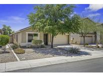 Charming single-story home with a well-manicured, low maintenance front yard and an attached two car garage at 40749 W Thornberry Ln, Maricopa, AZ 85138