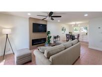 Inviting living room features a fireplace, TV, and modern ceiling fan at 5550 N 12Th St # 2, Phoenix, AZ 85014