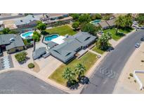 Expansive aerial view of a well-maintained home featuring a pool, lush landscaping, and an inviting outdoor space at 737 E 7Th Pl, Mesa, AZ 85203