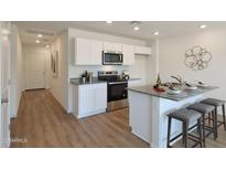 Charming kitchen features stainless steel appliances, granite countertops, and a breakfast bar with stool seating at 1179 N 13Th St, Coolidge, AZ 85128