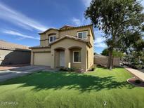Charming two-story home featuring well-maintained front yard and attached two-car garage at 13171 W Redfield Rd, Surprise, AZ 85379