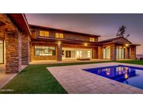 Gorgeous stone home showcasing a pool and outdoor living space at 15217 N 15Th Dr, Phoenix, AZ 85023