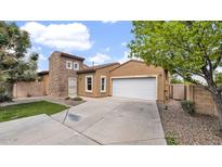 Charming single-Gathering home with a two-car garage and stone accents on a sunny day at 17132 W Tara Ln, Surprise, AZ 85388