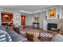 Elegant living room with a fireplace, stylish seating, and a decorative rug at 2402 E Esplanade Ln # 1101, Phoenix, AZ 85016