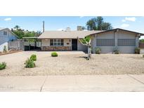 Charming single story home featuring a low maintenance desert landscaped front yard and attached carport at 3237 S Albert Ave, Tempe, AZ 85282