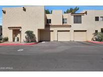 Image of a home's garages and covered parking with desert landscape and rock details at 3441 N 31St St # 118, Phoenix, AZ 85016
