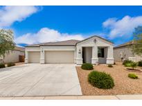 Charming single-story home with a three-car garage and low-maintenance desert landscaping at 3480 N 307Th Dr, Buckeye, AZ 85396