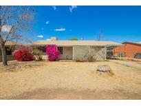 Charming single-story home featuring vibrant bougainvillea bushes and a covered carport at 3642 W Vernon Ave, Phoenix, AZ 85009