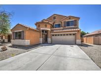 Beautiful two-story home featuring a spacious driveway, a two-car garage and classic Southwest architecture at 40437 W Robbins Dr, Maricopa, AZ 85138