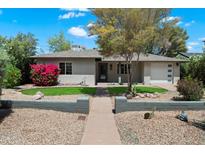 Charming single-story home featuring desert landscaping, a tidy lawn, and a welcoming walkway at 1106 W Glenrosa Ave, Phoenix, AZ 85013