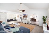 Bright, airy living room with a ceiling fan, decorative rug, and an open floorplan perfect for entertaining at 15212 N 53Rd St, Scottsdale, AZ 85254