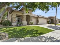 Beautiful single-story home with stone accents and a three-car garage on a well-maintained lawn at 2226 W Periwinkle Way, Chandler, AZ 85248