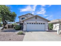 Charming two-story home featuring a well-manicured front yard and attached two-car garage at 2302 E Paraiso Dr, Phoenix, AZ 85024