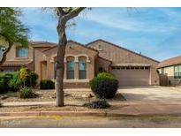 Charming single-story home featuring desert landscaping, a two-car garage, and a welcoming front entrance at 3038 W Trapanotto Rd, Phoenix, AZ 85086