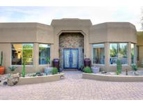 Home exterior featuring desert landscaping, stone details, and custom front door at 30600 N Pima Rd # 81, Scottsdale, AZ 85266