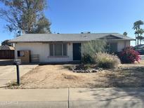 Modest single-story home featuring a desert-landscaped front yard and an attached single-car garage at 3556 E Helena Dr, Phoenix, AZ 85032