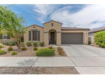 Charming single-story home with a well-manicured front yard and an attached two-car garage at 4150 S Neutron --, Mesa, AZ 85212