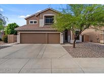 Two-story home featuring a three-car garage and desert landscaping at 5330 W Morgan Pl, Chandler, AZ 85226