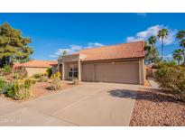 Charming single-story home with a terra cotta roof, desert landscaping, and a two-car garage at 5831 W Saragosa St, Chandler, AZ 85226