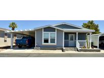 Charming home featuring a carport, desert landscaping, and a cozy front porch area at 650 N Hawes Rd # 2827, Mesa, AZ 85207