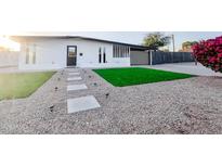 Charming home with a xeriscaped yard, stepping stone path, and a minimalist exterior at 7802 E Kimsey Ln, Scottsdale, AZ 85257