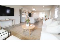 Open-concept living room with a modern design, island, sleek countertops, and stainless steel appliances at 7802 E Kimsey Ln, Scottsdale, AZ 85257