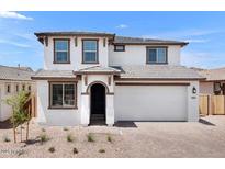 Charming two-story home boasts a neutral exterior with a two-car garage and well-manicured landscaping at 10912 E Tiburon Ave, Mesa, AZ 85212