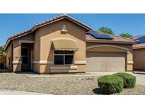 Charming single-story home with a two-car garage and well-maintained landscaping at 11664 W Eagle Ct, Surprise, AZ 85378