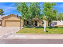 Charming single-Gathering home with a spacious front yard, mature trees, and an attached two-car garage at 1308 E Rosemonte Dr, Phoenix, AZ 85024