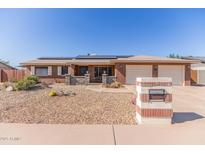Charming single-story home featuring a two-car garage, solar panels, and low-maintenance landscaping at 1348 W Rockwood Dr, Phoenix, AZ 85027