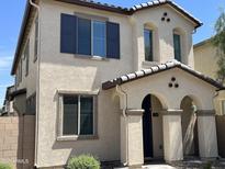 Charming two-story home featuring a stucco exterior, arched entryway and decorative window shutters at 1718 S 82Nd Way, Mesa, AZ 85209