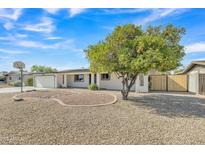 Cozy home featuring a mature citrus tree and a low-maintenance desert landscape at 2424 E Fairfield St, Mesa, AZ 85213