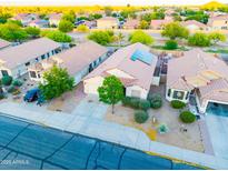 An aerial view shows the beautiful desert landscaping and tile roofs of this suburban neighborhood home at 33105 N Double Bar Rd, San Tan Valley, AZ 85144