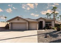 Charming single-story home with a well-maintained front yard, three-car garage and lovely desert landscaping at 341 E Constitution Dr, Gilbert, AZ 85296