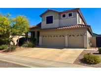 Two-story home with a two car garage, desert landscaping, and a red tiled roof in a suburban neighborhood at 4834 E Robin Ln, Phoenix, AZ 85054
