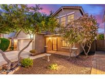 Charming two-story home featuring a well-maintained yard with trees and a cozy front porch at 5443 W Hobby Horse Dr, Phoenix, AZ 85083