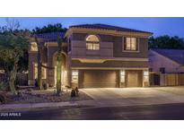 Inviting two-story home with a three car garage and desert landscaping at 6172 W Kerry Ln, Glendale, AZ 85308