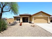 Charming single-story home with a two-car garage, low-maintenance landscaping, and a tiled roof at 10628 W Country Club Trl, Peoria, AZ 85383
