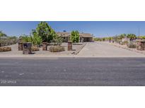 Charming front yard with desert landscaping and long driveway leading to the house at 10655 E Broadway Rd, Mesa, AZ 85208