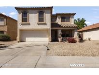 Charming two-story home featuring stucco siding, a two-car garage, and low maintenance desert landscaping at 12814 W Edgemont Ave, Avondale, AZ 85392