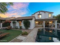 Expansive backyard featuring a pool, patio, and lush landscaping for relaxation and outdoor enjoyment at 13131 N 153Rd Ave, Surprise, AZ 85379