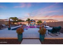 A beautiful backyard pool with a gazebo, basketball court, and plenty of seating for entertaining at 14979 S 184Th Ave, Goodyear, AZ 85338