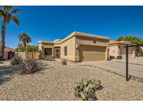 Southwest-style home featuring desert landscaping, including gravel, cacti, and a two-car garage at 17323 E Teal Dr, Fountain Hills, AZ 85268
